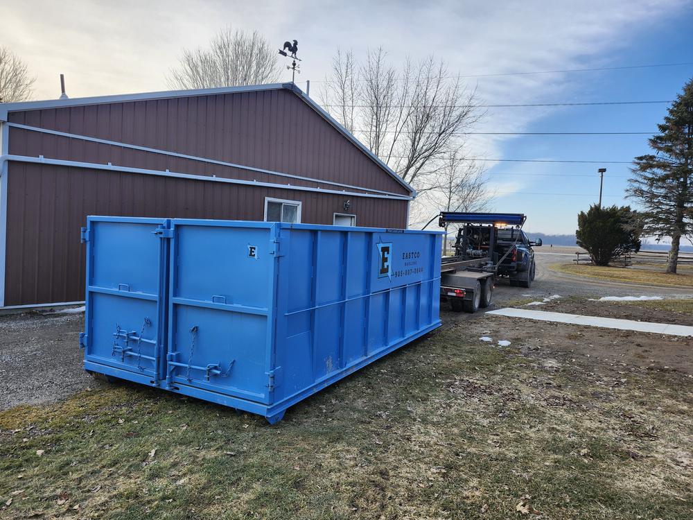 Large Eastco roll-off bin placed at a job site