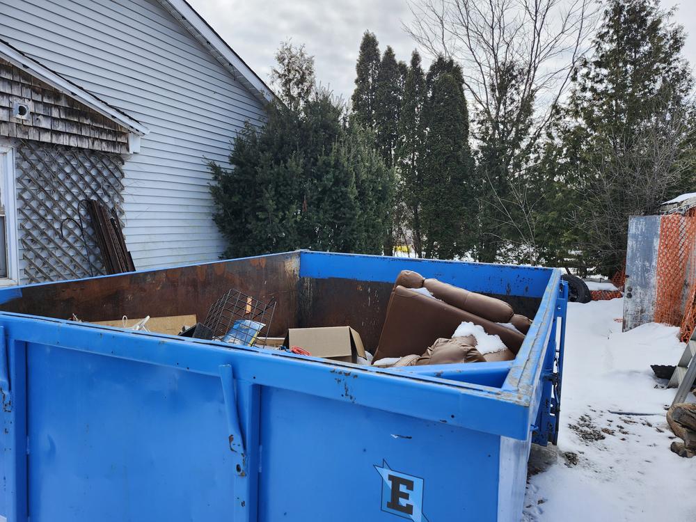 Eastco bin loaded with renovation debris