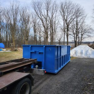 Eastco Hauling 14 yard roll-off bin being delivered